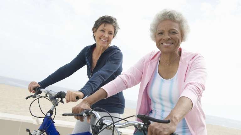 two women riding bikes in manhattan