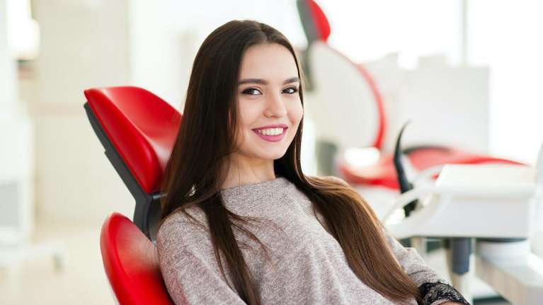woman sitting in dental chair in a midtown manhattan office